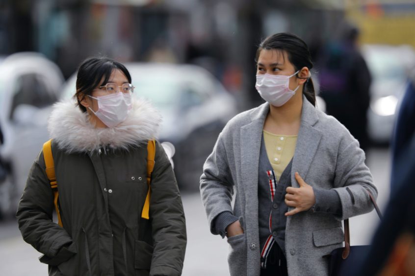 Two women wearing face coverings in Dundee.
