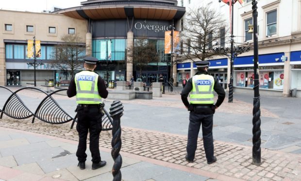 Police patrolling a deserted Dundee City Square during the initial lockdown.