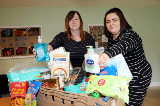 Courier Fife news CR0020549 G Jennings pics, the Cottage Family Centre Pauline Buchan (strategic manger) & Lana Moffat (family services co ordinator) pack the boxes.