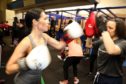 Gayle sparring with coach Niki Bain at Skyaxe Boxing Gym.