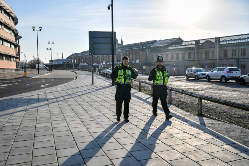 British Transport Police patrol the perimeter of Bristol Temple Meads train station, which is empty of rush-hour commuters and travelers at 8am the day after Prime Minister Boris Johnson put the UK in lockdown to help curb the spread of the coronavirus.