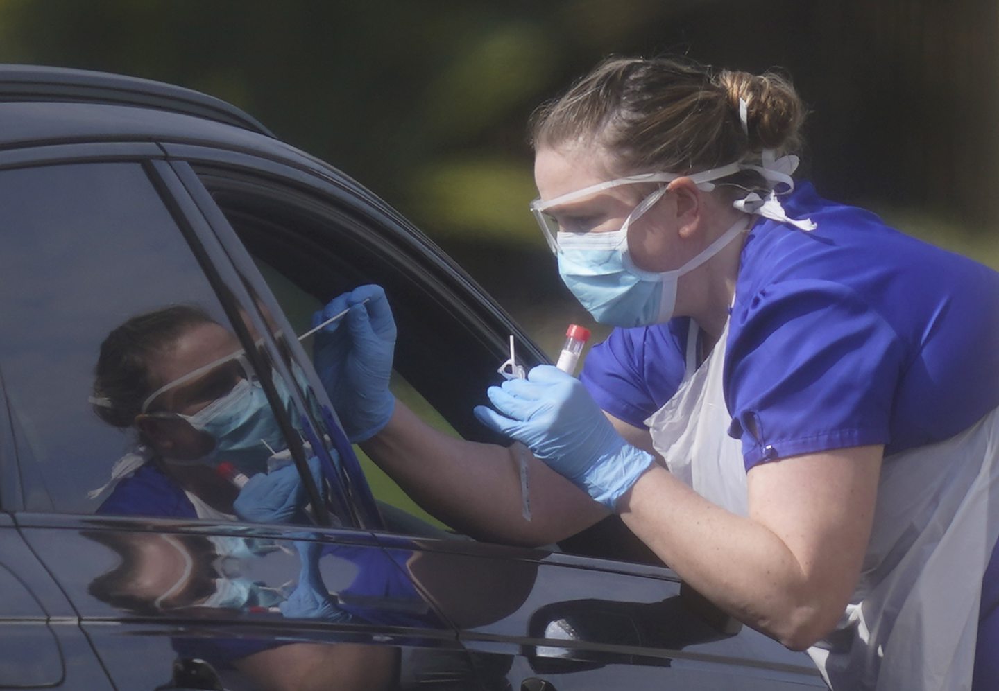 An NHS worker being tested for coronavirus at a temporary testing station in the car park of Chessington World of Adventures in Chessington, Greater London.