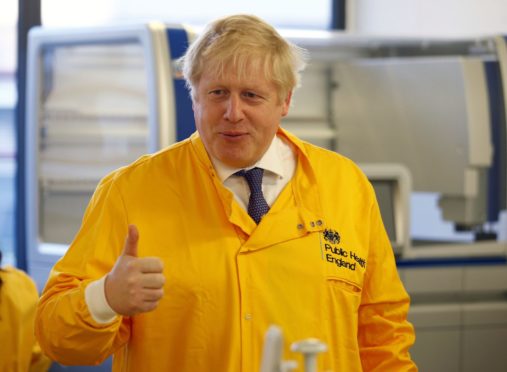 Prime Minister Boris Johnson visits a laboratory at the Public Health England National Infection Service in Colindale, north London.