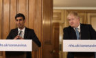 Chancellor Rishi Sunak with Prime Minister Boris Johnson during a media briefing in Downing Street, London, on Coronavirus.