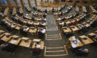 MSPs social distancing with every second seat removed at the Scottish Parliament, Holyrood.