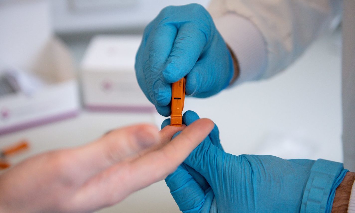 Capillary blood is drawn from a fingertip during a demonstration at SureScreen Diagnostics, based in Derby, of a test they have manufactured which claims to be 98% accurate in determining if a person is infected with coronavirus, costs £6 and can be used in 10 minutes.