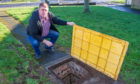 Neil Finlayson beside the massive manhole.