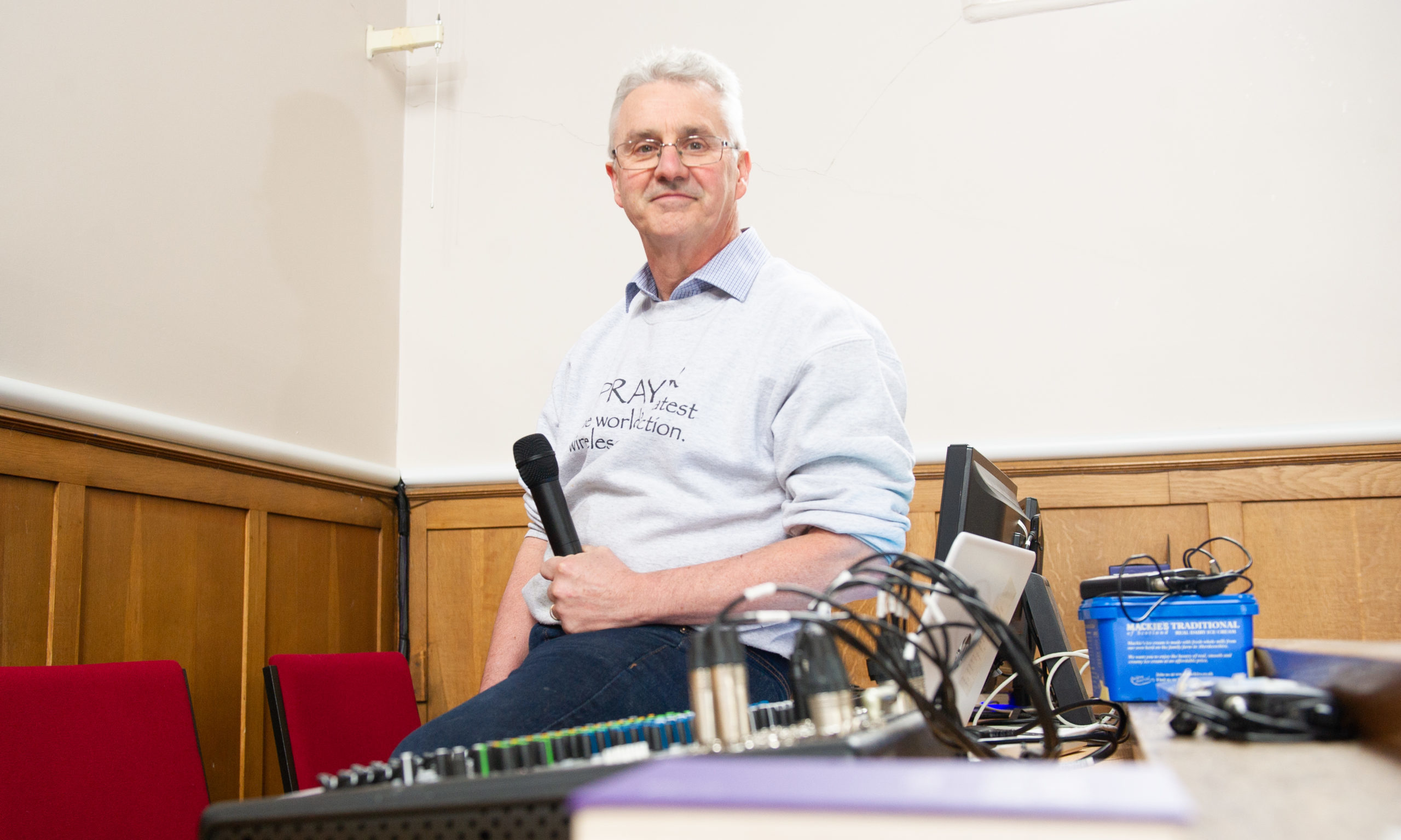 Rev Graham Crawford with some of the equipment installed last year to enable services to be broadcast.