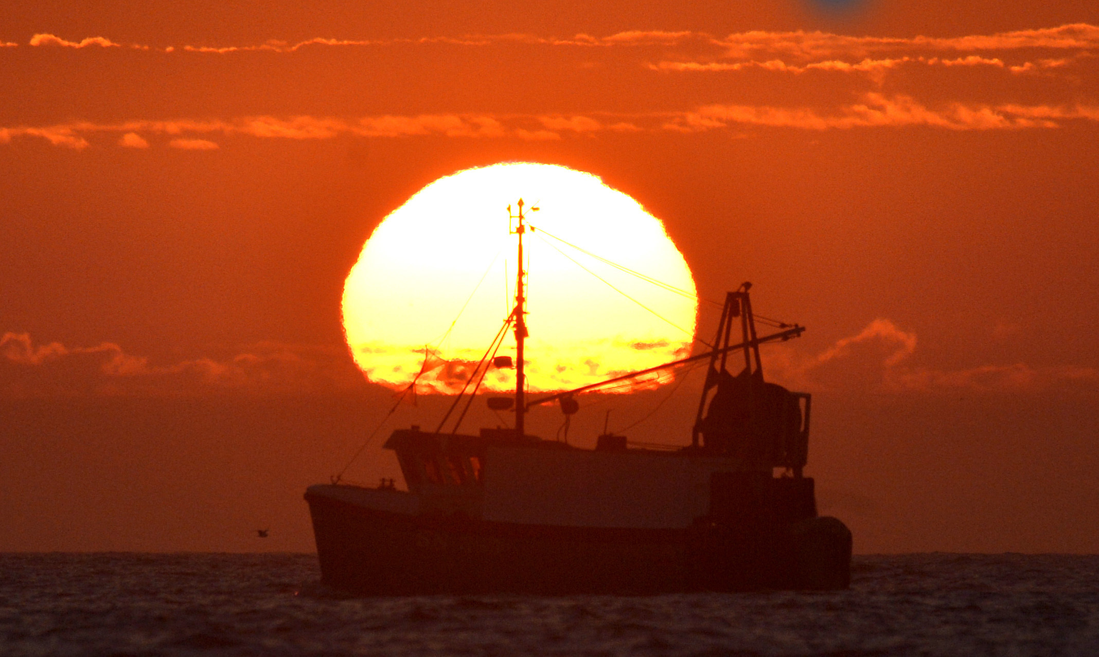 The sun rises over fishermen setting off for a day's fishing on the North Sea.