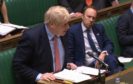 Health Secretary Matt Hancock watches Prime Minister Boris Johnson speak during Prime Minister's Questions in the House of Commons.