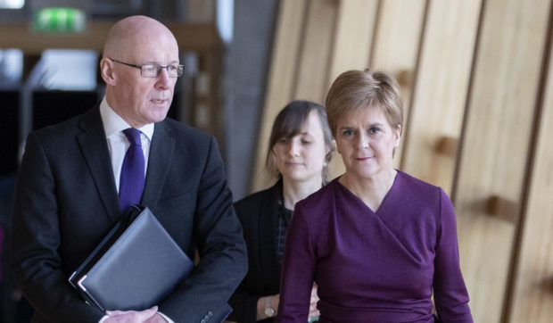 John Swinney and Nicola Sturgeon on their way to the Scottish Parliament debating chamber on Thursday.