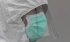 A healthcare worker wears protective gear during the coronavirus outbreak in Madrid, Spain.