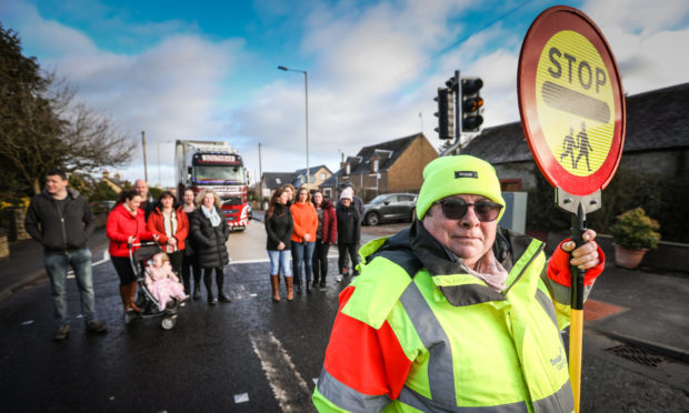 Lollipop Lady Yvonne Nicol and parents want to see the cuts reversed.