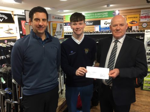 Young pro Alex Simpson receives a grant from Charlie Gallagher (right), a trustee with the Barrie Douglas Foundation, with Niall McGill looking on.