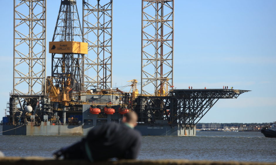 A man watches on as the rig sails down the Tay.