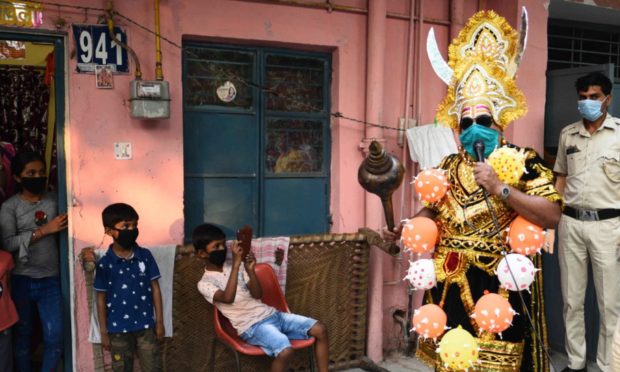 A central government employee dressed as Yamraj or Hindu god of death