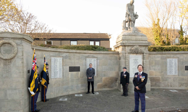 Standard bearers Paul Thomson and Rab Cumming, Darrell Milton, a former Commander in the Royal Australian Navy,  Carnoustie legion vice-chairman Danny Downs and Legion chairman Davie Paton
at the Carnoustie memorial.