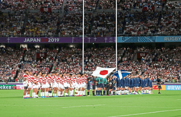 Japan and Scotland observe a minutes silence for the victims of Typhoon Hagibis during the 2019 Rugby World Cup match at the Yokohama Stadium, Yokohama. PA Photo. Picture date: Sunday October 13, 2019. See PA story RUGBYU Scotland. Photo credit should read: David Davies/PA Wire. RESTRICTIONS: Editorial use only. Strictly no commercial use or association. Still image use only. Use implies acceptance of RWC 2019 T&Cs (in particular Section 5 of RWC 2019 T&Cs) at URL: bit.ly/2knOId6