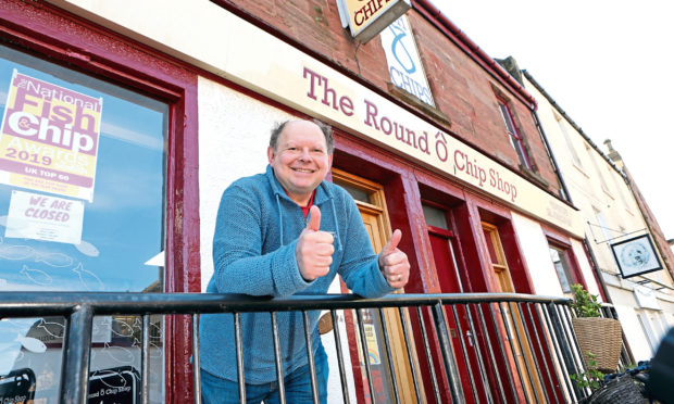 Stuart Atkinson outside one of his chip shops.