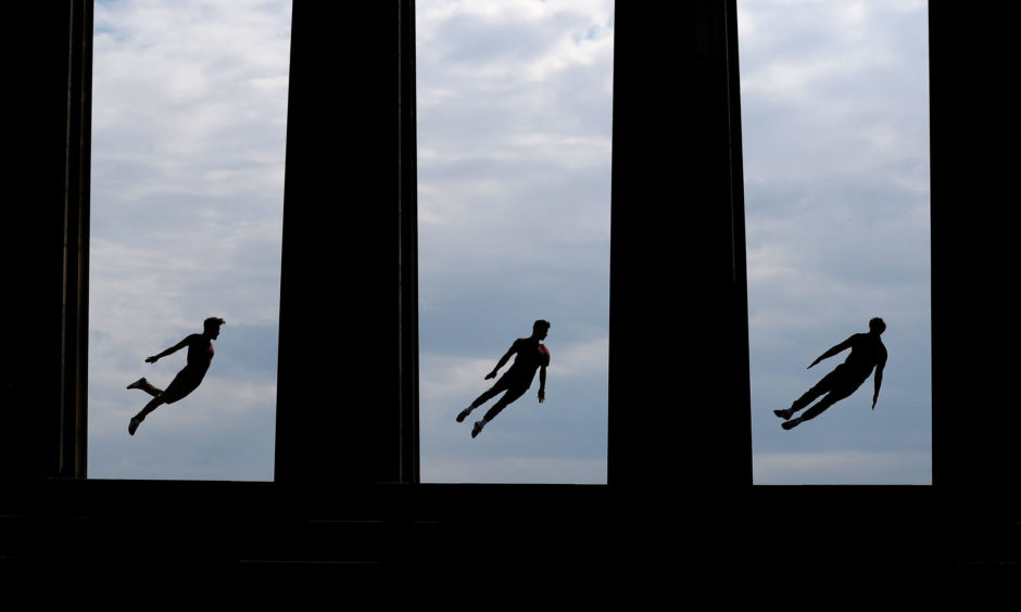 Acrobats Beren d'Amico, Louis Gift and Charlie Wheeller, from Barely Methodical Troupe perform a routine on Calton Hill in Edinburgh as they brought their debut show Bromance to the Edinburgh Fringe 2019.
