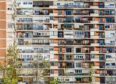 An anonymous apartment block with balconies full of various objects in Spain, a prime example of where the Gitano live.