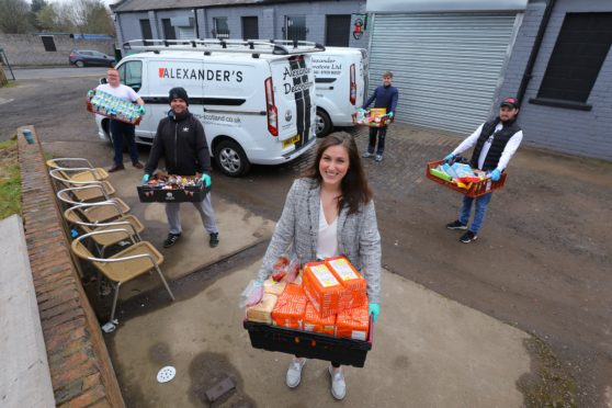 John Alexander, Murray Duncan, Kara Swankie, George Alexander and Charlie Lamont at Alexander Community Development with some of the food they are storing and distributing across Dundee.