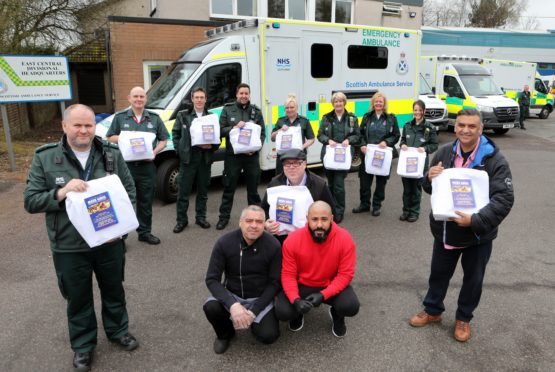 Stuart Payne (front left), area services manager and the rest of the Scottish Ambulance staff at the Scottish Ambulance Station on West School Road Dundee were treated to meals from Ibrar Ibrahim (front right) ,owner of the " Meze Grill" in Broughty Ferry