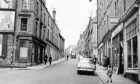 An old photograph looking upwards towards the Hawkhill Shops (Old Westport) from the bottom of Westport, Dundee.