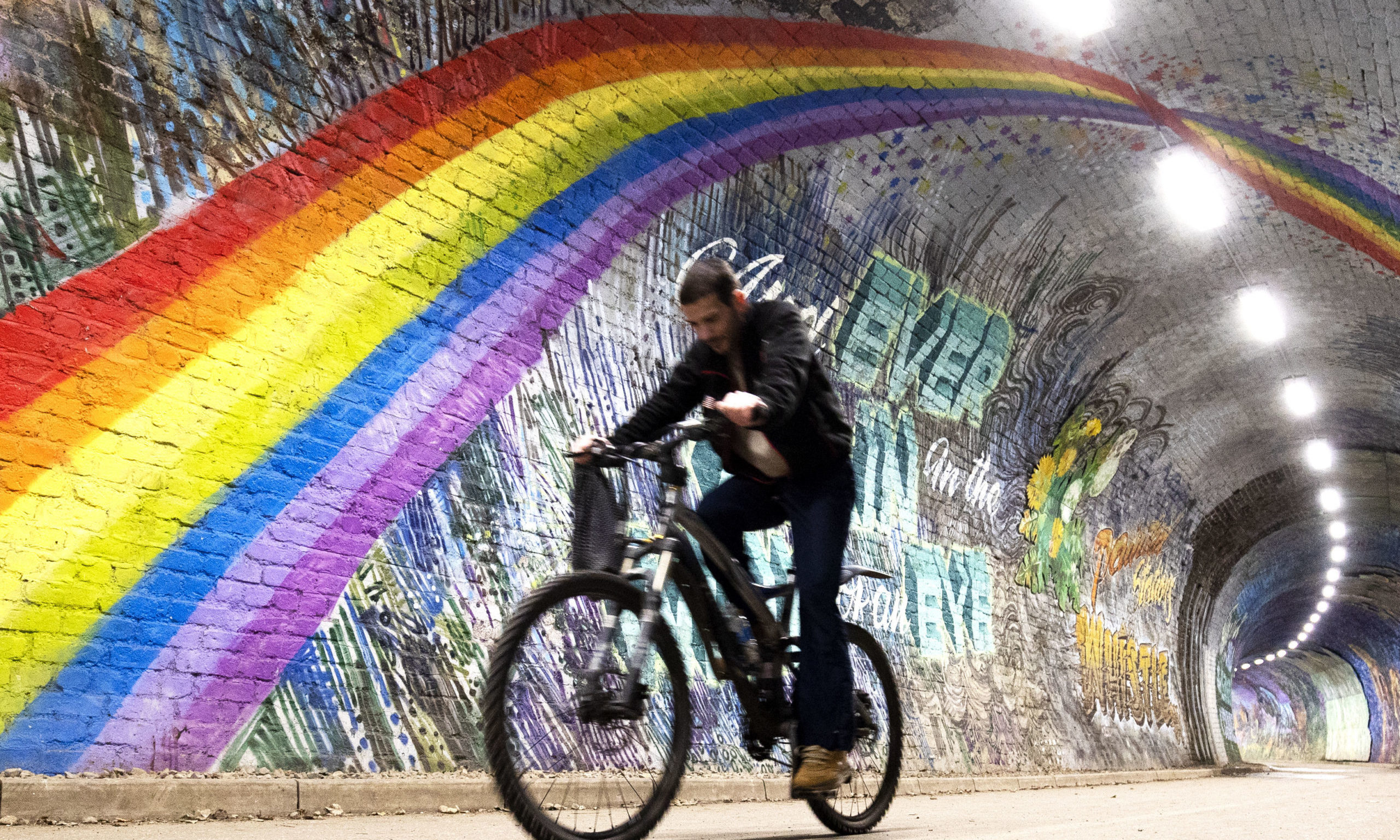 A cyclist passes underneath the rainbow mural in Colinton Tunnel, Edinburgh, as the UK continues in lockdown to help curb the spread of the coronavirus. PA Photo. Picture date: Tuesday April 21, 2020. See PA story HEALTH Coronavirus. Photo credit should read: Jane Barlow/PA Wire