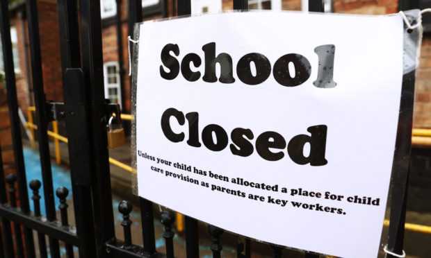 A sign on the gates of a closed school during the lockdown.
