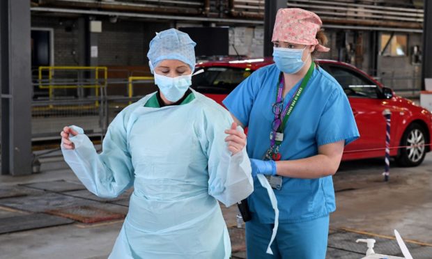 Medical staff tackling Covid-19 put on their personal protective equipment (PPE).