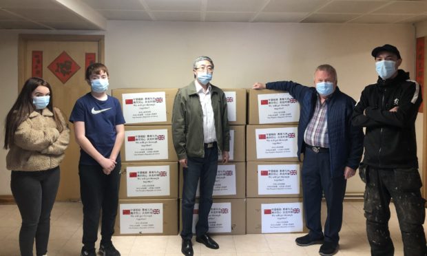 From left: Kaela Mak, Damon Mak, Consul General Ma Qiang, David Valentine and Damian Mak who volunteered to take the masks to Angus from Edinburgh.