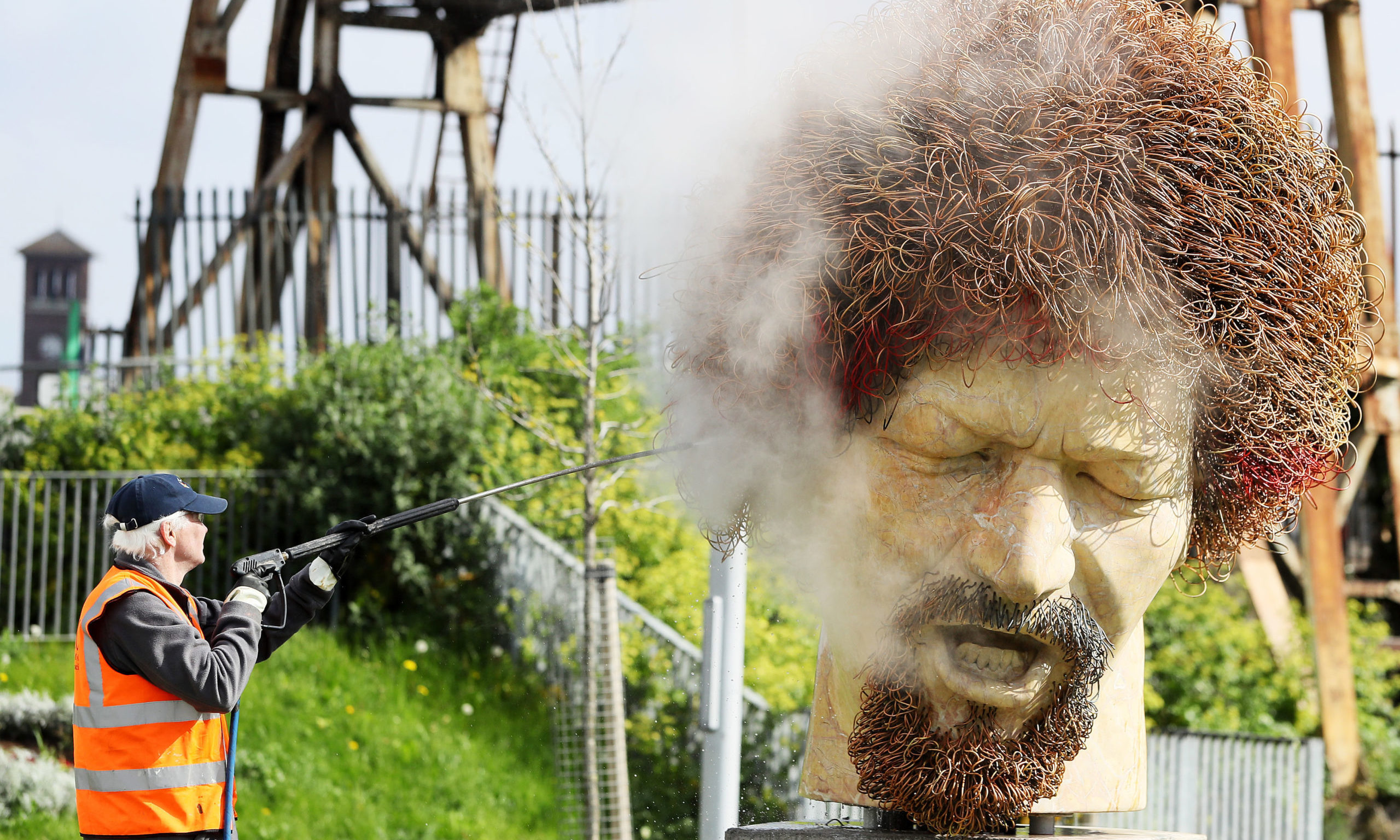 Ross Sheridan of P.Mac Cleaning and Restoration services working on behalf of Dublin City Council cleans a statue of the late musician Luke Kelly in the Sherriff street area of Dublin, after it was defaced for the fourth time in the past year.