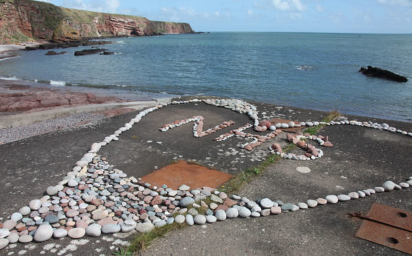 The NHS Heart is being filled with heart-shaped stones at Auchmithie.