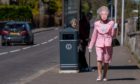 Pensioner Hazel MacFadyen begins first of 45 daily walks dressed as the Queen.