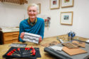 Linda Farquharson in the studio with the stamps that she helped produce.
