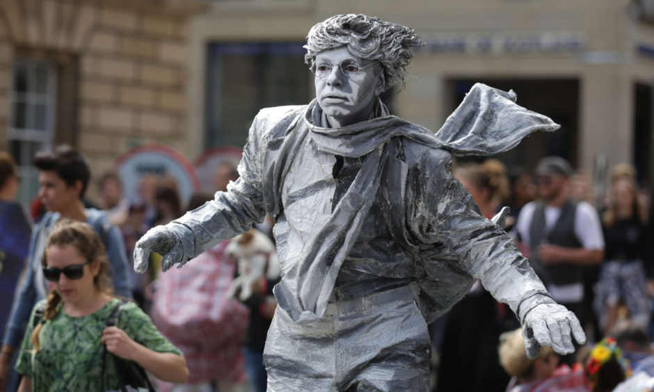 Fringe Festival acts perform on the Royal Mile, Edinburgh.