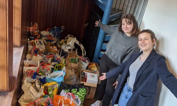 Students Lottie Doherty and Ruby Newsham with foodbank donations.