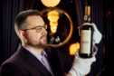 Whisky Auctioneer founder Iain McClune with the rare Macallan