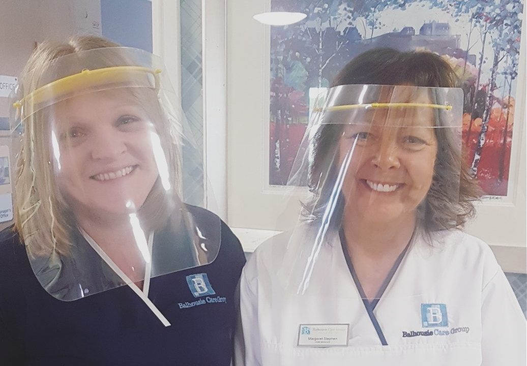 Staff at Balhousie Clement Park model the visors made by Design & Technology school teachers in Dundee