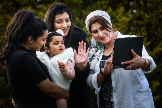 Aunties Yusra Ramzan, 20, Maliha Ramzan, 23, and granny Fatima Ramzan with baby Hoorain Siddiqui, 1 and a half doing a videocall with family to keep in touch.