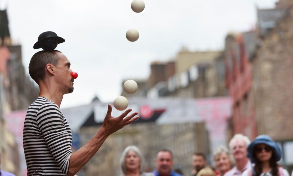 Entertainers perform on the Royal Mile.