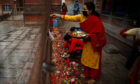 A small number of devotees offer prayers on the 22nd day of lockdown at Balkumari temple