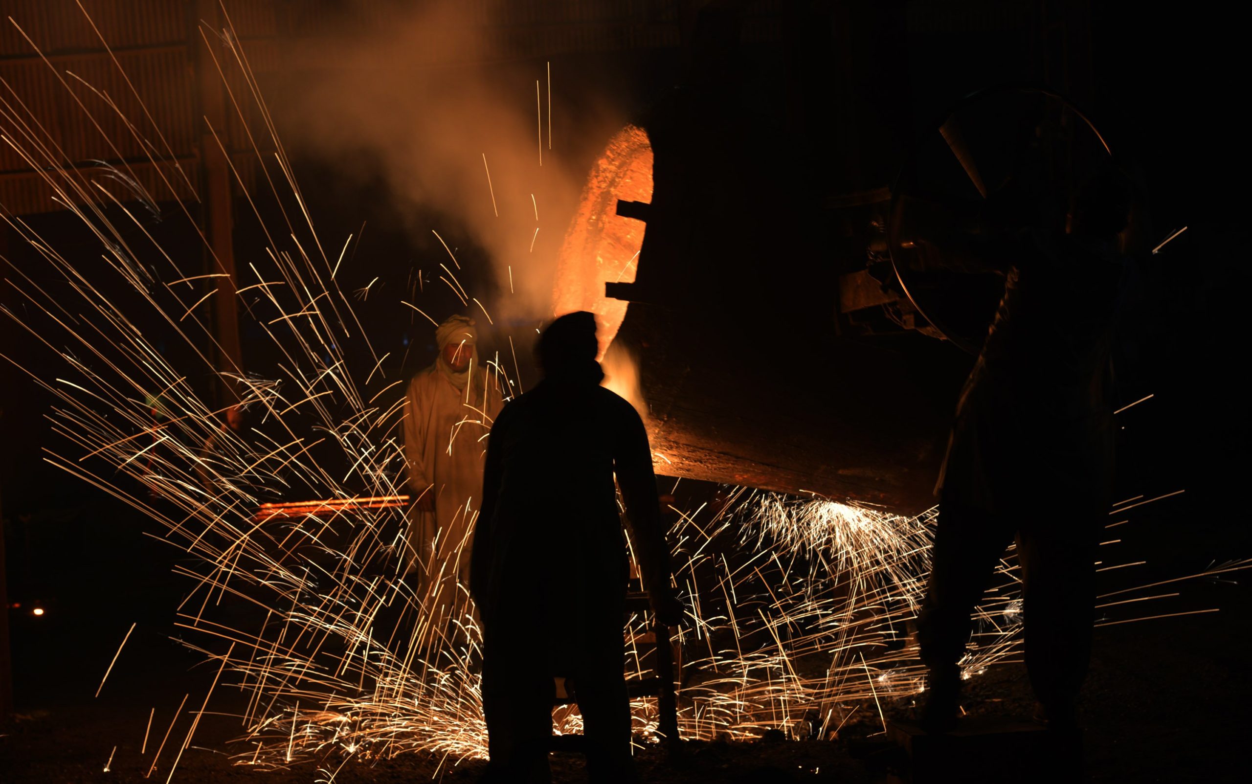 Pakistani blacksmiths work at an iron molding factory in industrial area ahead of International Labor Day.