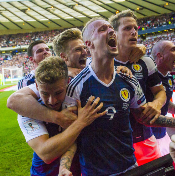 Scotland striker celebrates scoring second of his famous free-kick double