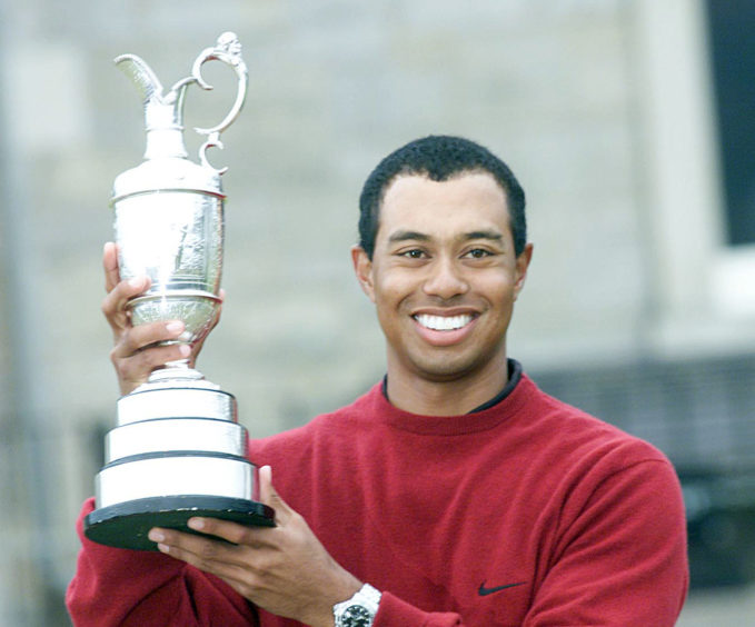 Tiger Woods with the famous Claret Jug after victory at the 2000 Open Championship at St Andrews.