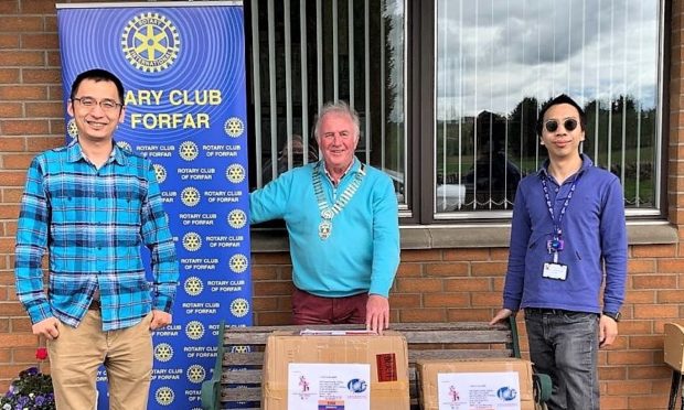 Dr Yang and Dr Gu with Forfar Rotary president Doug McFarlane.