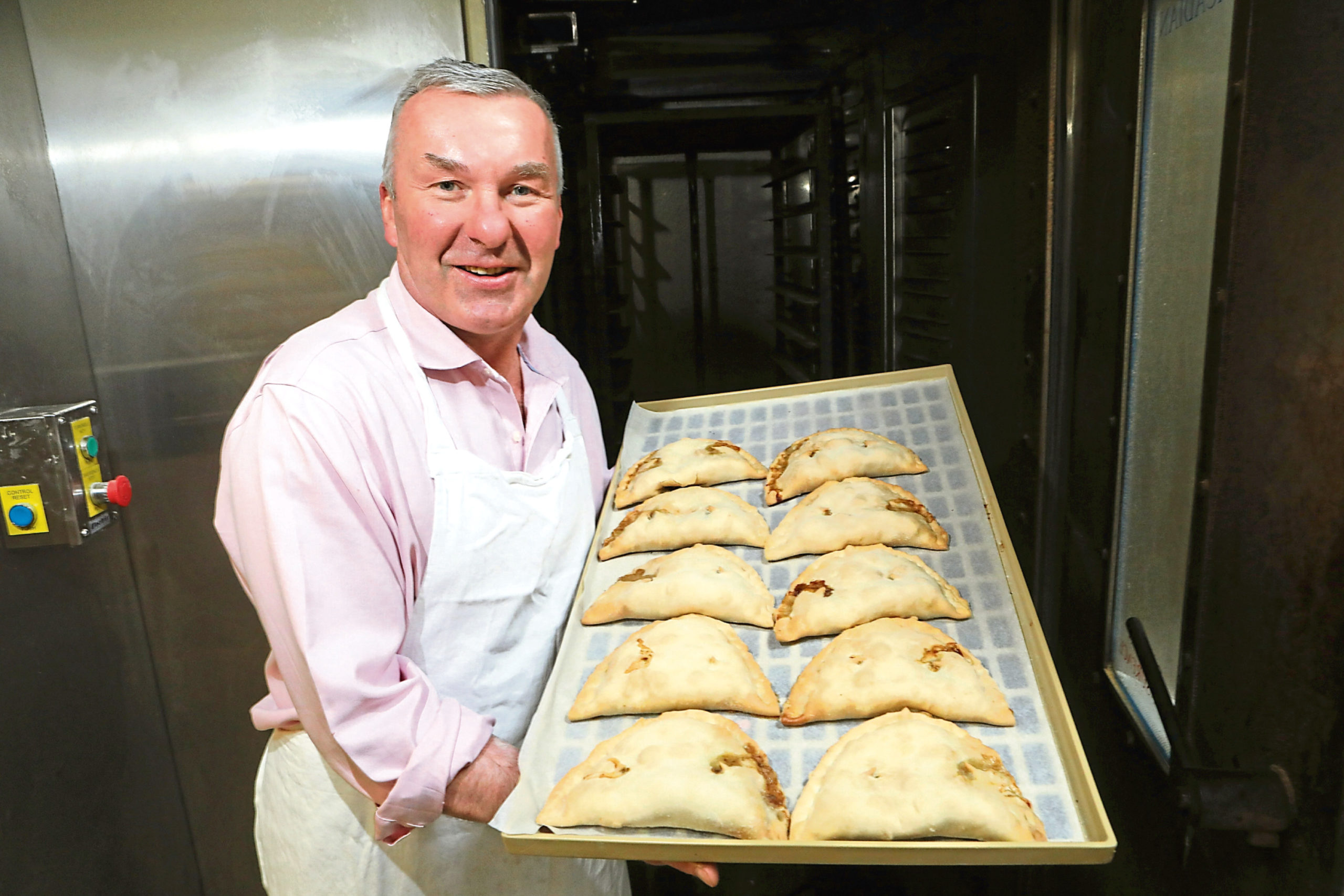 MIchael Saddler with a tray of bridies just out of the oven.
