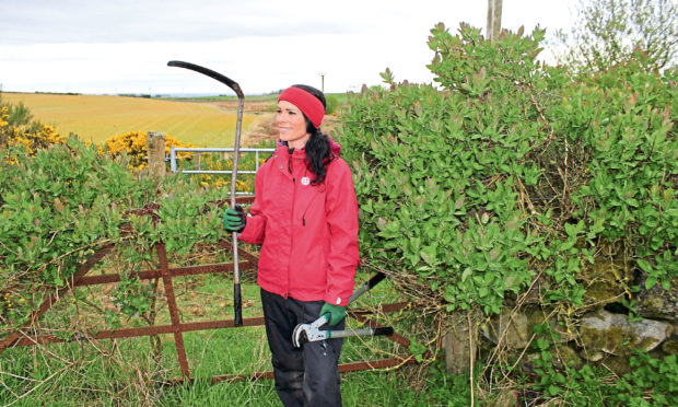 Gayle sets out with various tools to clear an old right of way.