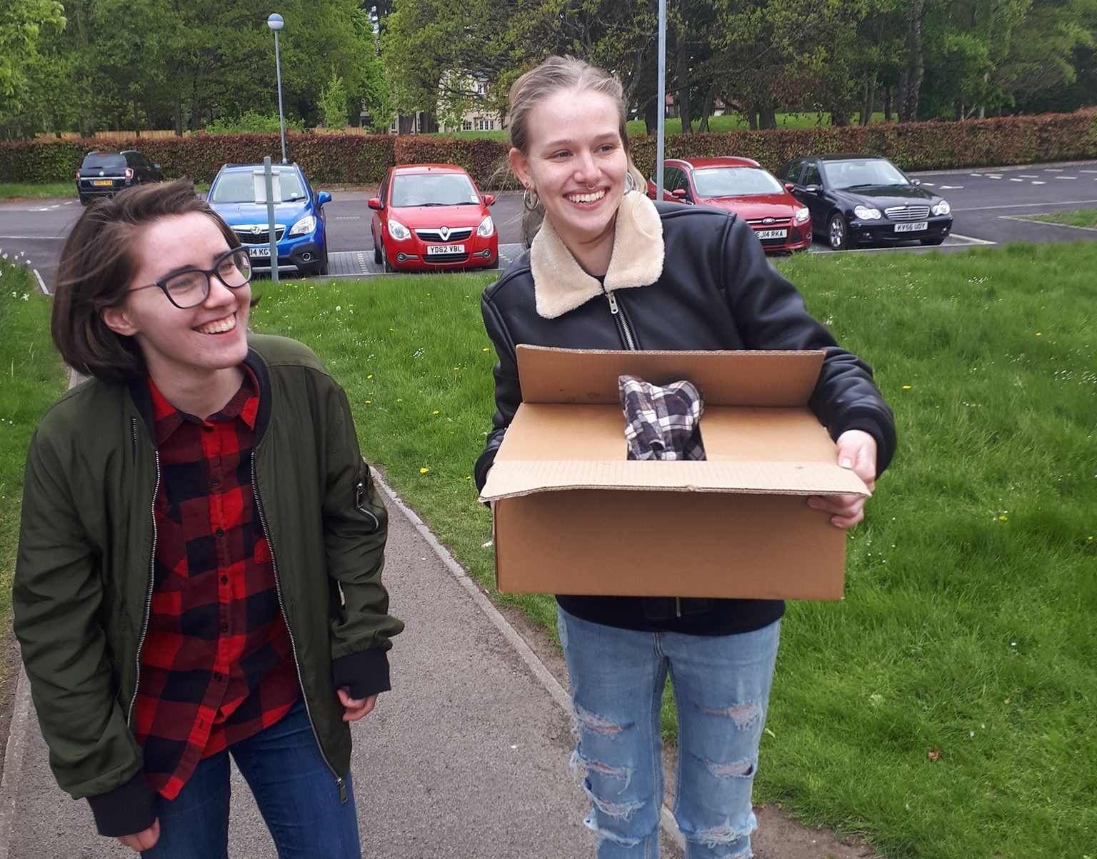 Erin (left) and Katy carry the duck in a box © John Fettes
